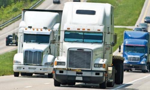 Trucks driving uphill on highway