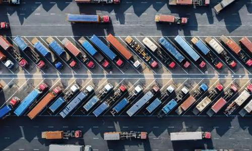 aerial view of dozens of semi trucks